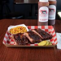 1/2 Rack St. Louis Ribs · 6 bones of ribs slow cooked over a wood fire.  These ribs are kissed with just a glaze of sa...