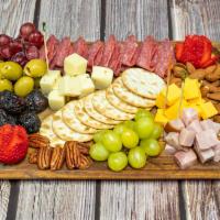 Charcuterie Board  · Olives, salami, ham, cheeses, fresh fruits, dried fruits, nuts.