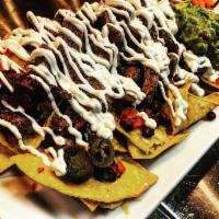 Macho Nachos  · Shredded steak or chicken, guac, pico-de-gallo, sour cream, jalapenos, beans.