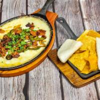 Queso Fundido · Melted cheeses, chorizo, onions. Chopped jalapenos. Side of chips and tortilla.