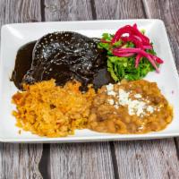 Chicken Mole · Leg and thigh, mole chocolate sauce (contains nuts), rice and beans.