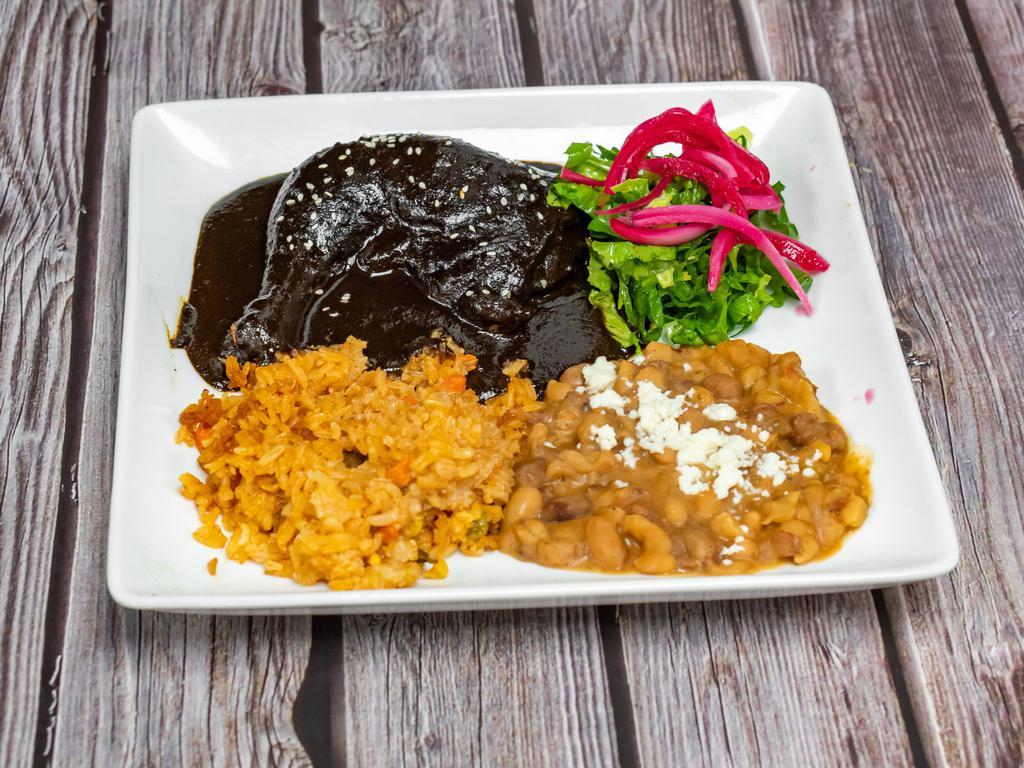 Chicken Mole · Leg and thigh, mole chocolate sauce (contains nuts), rice and beans.