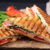 Mexican Steak Panini · Savory steak, cilantro, avocado, hot peppers, lettuce, tomato, onions, and chipotle mayo.