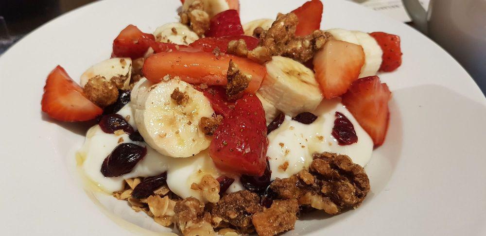 Yogurt Parfait  · House-made cranberry granola, vanilla yogurt, seasonal fruit, walnuts, and honey. Vegetarian.