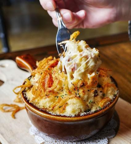 Macropolis Macaroni and Cheese · With smoked gouda sauce, bacon, crispy onions, and truffle oil with a parmesan crust.