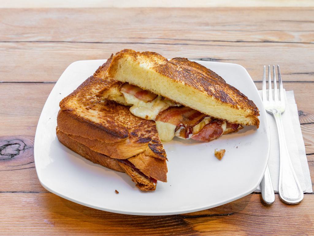 Gooey Grilled Cheese Sandwich · Gouda and gruyere cheeses melted in grilled brioche with fig marmalade and bacon.