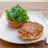 Grilled Salmon Burger · Salmon patty topped with arugula and tomato in a house-made tartar sauce.