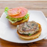 Turkey Burger · Turkey patty with lettuce, tomato, and avocado spread in a burger bun.