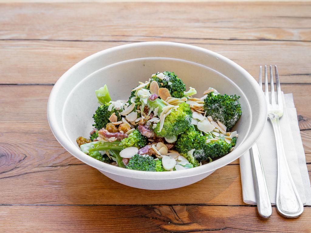 Broccoli Salad · Steamed and immediately cooled broccoli, tossed with panchetta, onions toasted almond and raisins. Lightly marinated with vinegar and mayo.