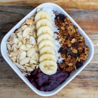 Acai Bowl · Acai puree mixed with berries and almond milk topped with almond slices, granola, coconut sh...