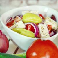Greek Salad · Tomatoes, cucumber, onion and feta cheese. Vegetarian and gluten free.