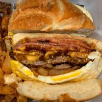 The King Neptune · Sausage, bacon & pork roll stacked tall with eggs, american cheese & breakfast potatoes on a...