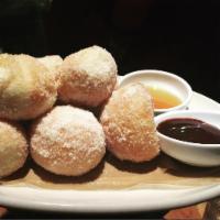 House-Made Doughnuts · With your choice of local Dallas honey or chocolate sauce.