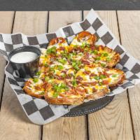 Irish Nachos · Potato slices fried to perfection and generously covered with cheddar-jack, bacon pieces, an...