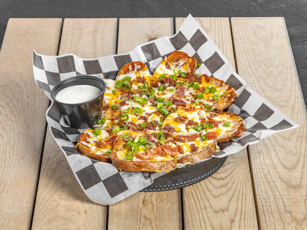 Irish Nachos · Potato slices fried to perfection and generously covered with cheddar-jack, bacon pieces, and scallions! Served with ranch! Add protein for an additional charge.