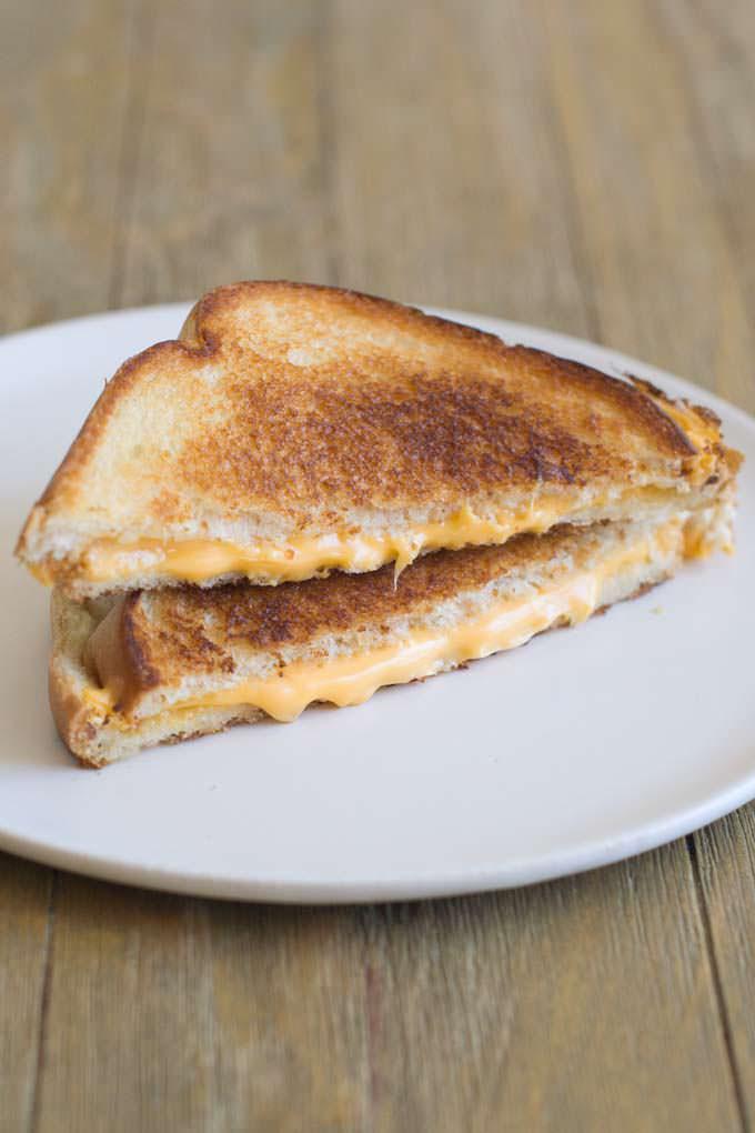 Kid's Grilled Cheese Madness · White cheddar, yellow cheddar, American cheese, butter white bread and french fries.