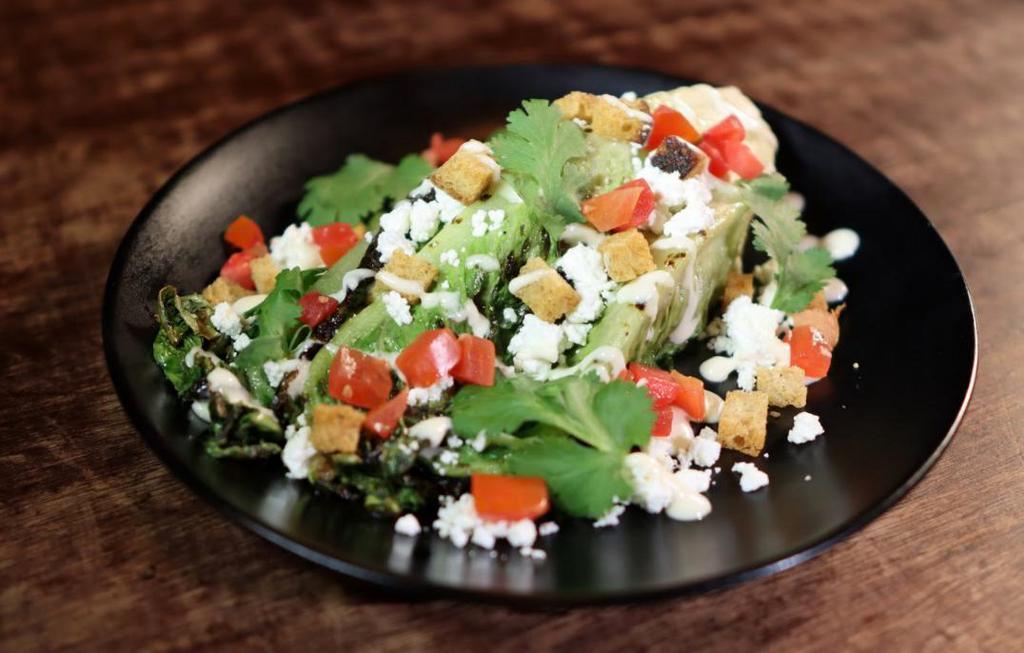 Caesar Salad · Grilled Romaine, Parmesan Cheese, Diced Tomato, House Croutons, Caesar Dressing.