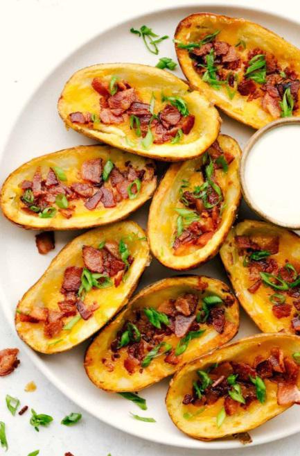 Potato Skins  · Baked potatoes topped with cheddar cheese, bacon, and chives, served with sour cream. 