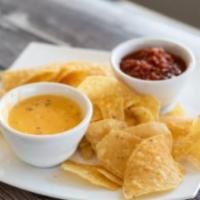 Queso, Chips, and Salsa · Zesty queso and homemade salsa served with fresh tortilla chips.