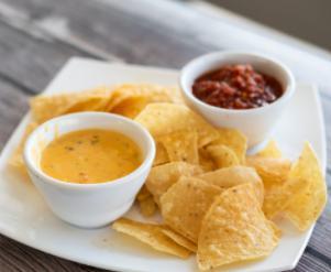 Queso, Chips, and Salsa · Zesty queso and homemade salsa served with fresh tortilla chips.