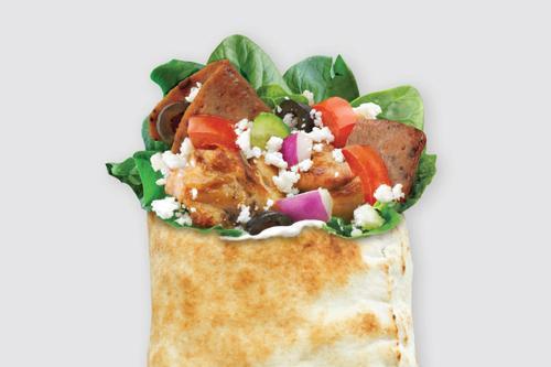 Super Greek with Schug Pita · Gyro and chicken souvlaki with spinach, tomatoes, cucumbers, onions, black olives, feta and tzatziki, and Schug sauce.