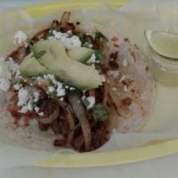 Monster taco · Home made Tortilla  beef fajita with grilled onions on top  covered with white Mexican queso...