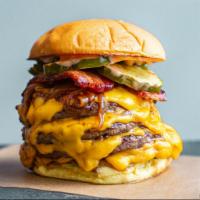 The Quad Burger · Four patties of your choice dusted with Pop’s seasoning, red wine and grass-fed butter sauce...