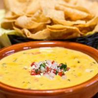 Chile con Queso · Creamy cheeses melted and mixed with tomatoes, onions, jalapeños, cilantro, and spices.