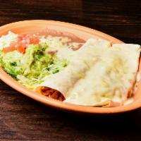 Burritos Tipicos · Two burritos filled with beef tips and topped with cheese sauce. Served with refried beans a...