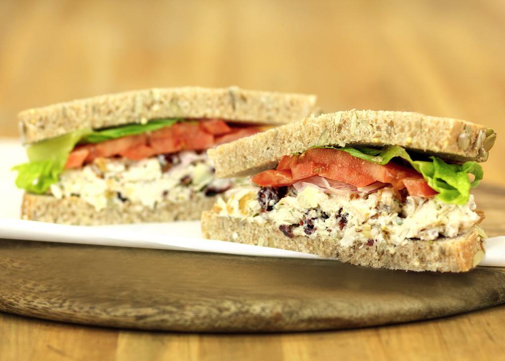 Big Sky Chicken Salad Sandwich · White meat chicken mixed with golden raisins, cranberries, artichoke hearts, herbs, lemon, and walnuts. Served on Honey Whole Wheat bread with lettuce, tomato, onion, and salt & pepper mix.