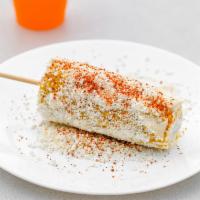 Elote · Corn cob on a stick covered with mayo, sour cream, cotija cheese, and chili powder.