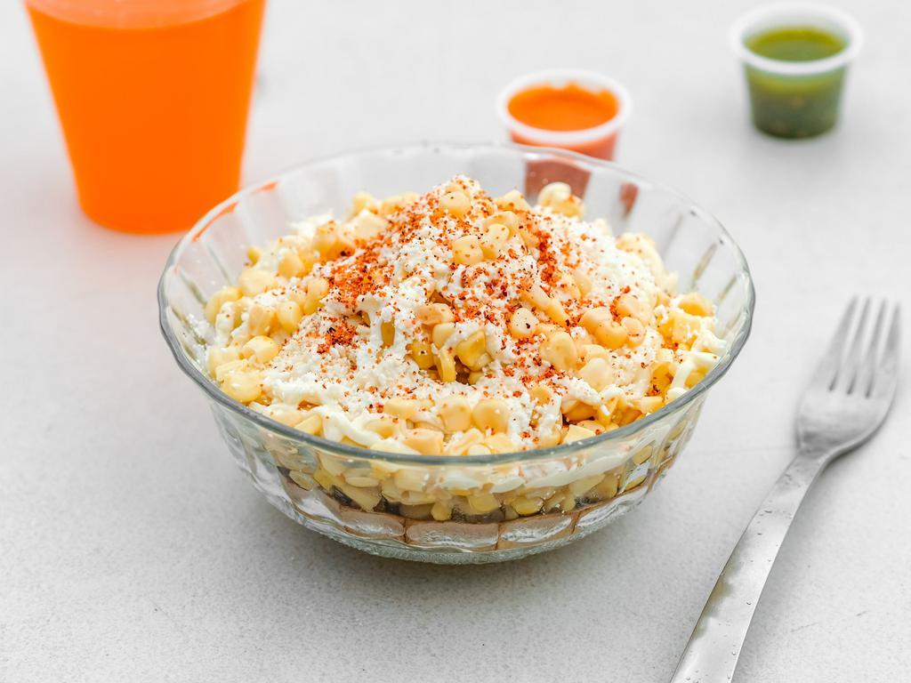 Esquite · Corn grains served hot on a cup and topped with mayo, sour cream, cotija cheese, and chili powder.