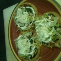 Bistec Sope · 3 sopes with refried beans, onions, cilantro, lettuce, tomato, steak, cotija cheese, and sou...