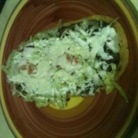 Bistec Huarache · 1 huarache with black beans, lettuce tomato, steak, sour cream and cotija cheese.