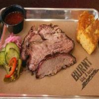Smoked Brisket 1/2# · Our signature brisket is rubbed with love and coffee grind.