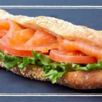 Smoked Salmon Sandwich · Smoked salmon, tomato, lettuce & lemon spread on a sesame seed baguette.