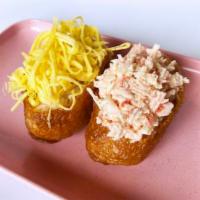 Inari Sushi · Sushi rice stuffed into simmered fried tofu pockets, topped with baked crab mix and egg garn...