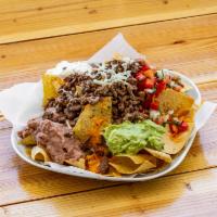 Super Nachos · Chips covered with cheddar cheese, beans, guacamole, sour cream, carne asada and pico de gal...