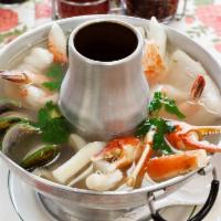 8. Spicy Seafood Soup + White Rice · Hot pot. Lemon grass, lime, crab, shrimp, calamari, mussels, fillets.
