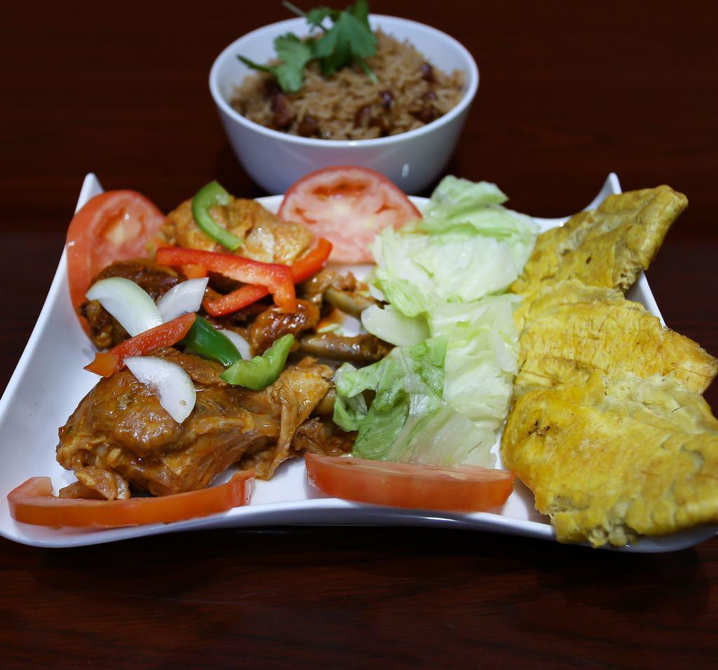 Stewed Chicken · Served with rice and beans, fried plantain and salad.