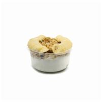 Coco Bowl · Topped with granola, banana and honey. Made with raw coconut, banana and coconut milk.