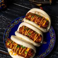 Seafood Croqueta Bao · Krab and  shrimp croqueta drizzled with our spicy aioli.