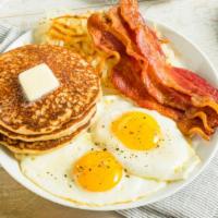 Pancakes eggs & sausage · Three butter milk pancakes, 2 sunny side up eggs, bacon straps and sausages
