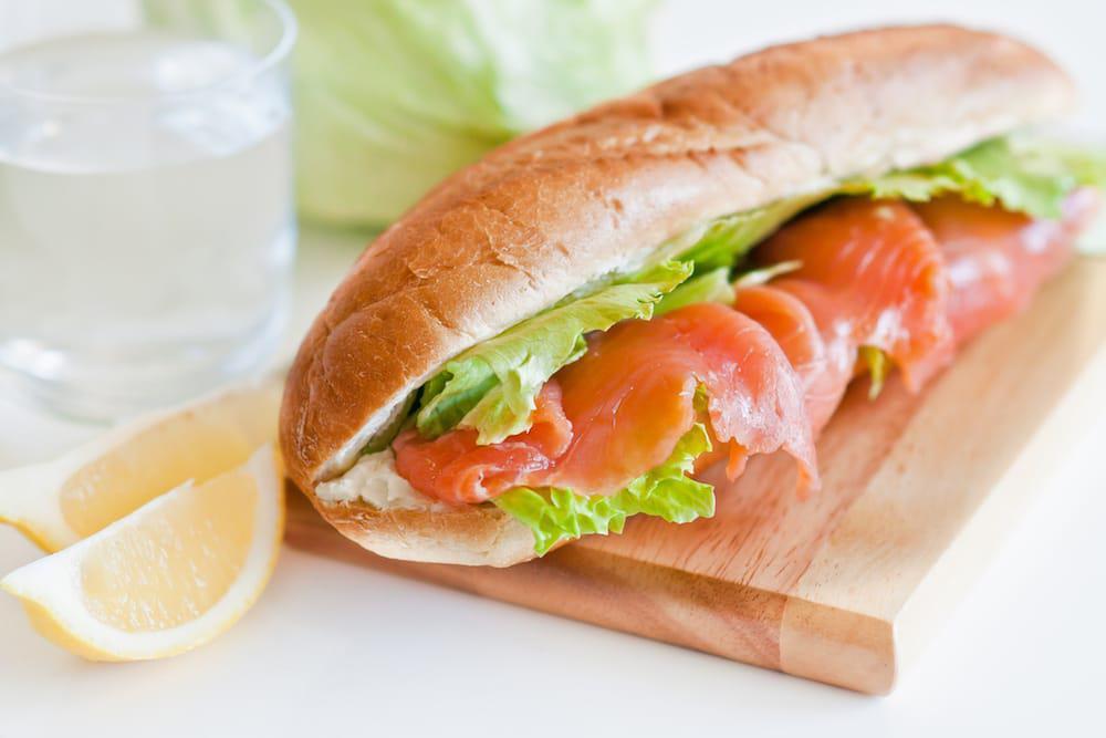 Smoked Salmon Sandwich with chips · Salmon, onion, capers, cream cheese, tomatoes