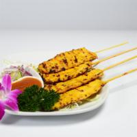 Satay Chicken · Marinated chicken with fresh herbs, spices, and grilled. Served with cucumber salad and pean...
