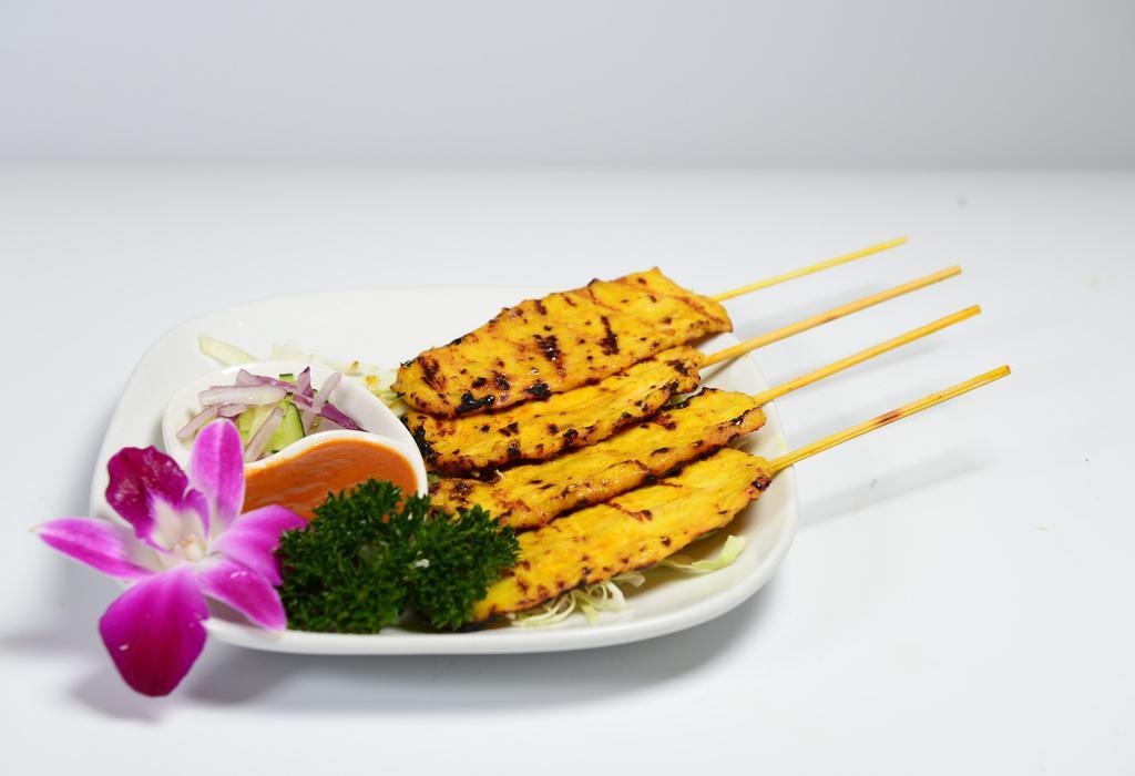 Satay Chicken · Marinated chicken with fresh herbs, spices, and grilled. Served with cucumber salad and peanut sauce.