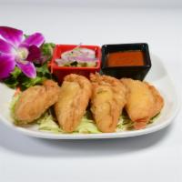 Thai Curry Puff · Chicken with yellow curry, potatoes, onions, and folded into pastry puffs. Served with cucum...