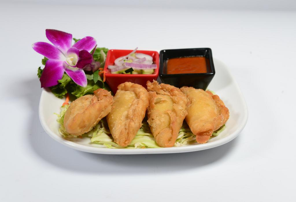 Thai Curry Puff · Chicken with yellow curry, potatoes, onions, and folded into pastry puffs. Served with cucumber and peanut sauce.