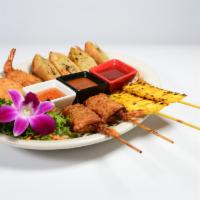 Appetizer Combo · Combination of chicken satay, Thai stick, fried tofu, and veggie eggs roll. Served with sauc...