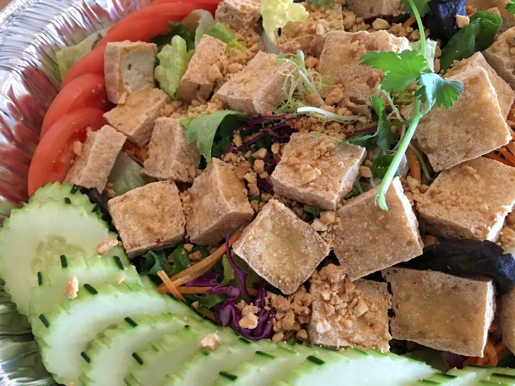 House Salad · Romaine, lettuce, onions, tomato, tofu, carrots, and cucumbers. Topped with tasty peanuts and dressing.